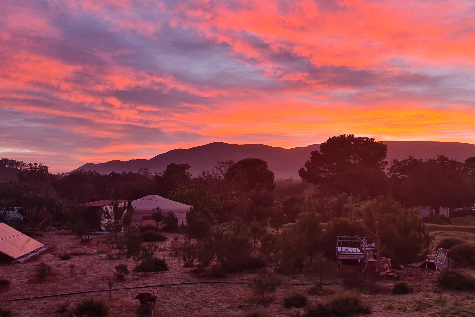 Sunset over the farm with mountains in the distance
