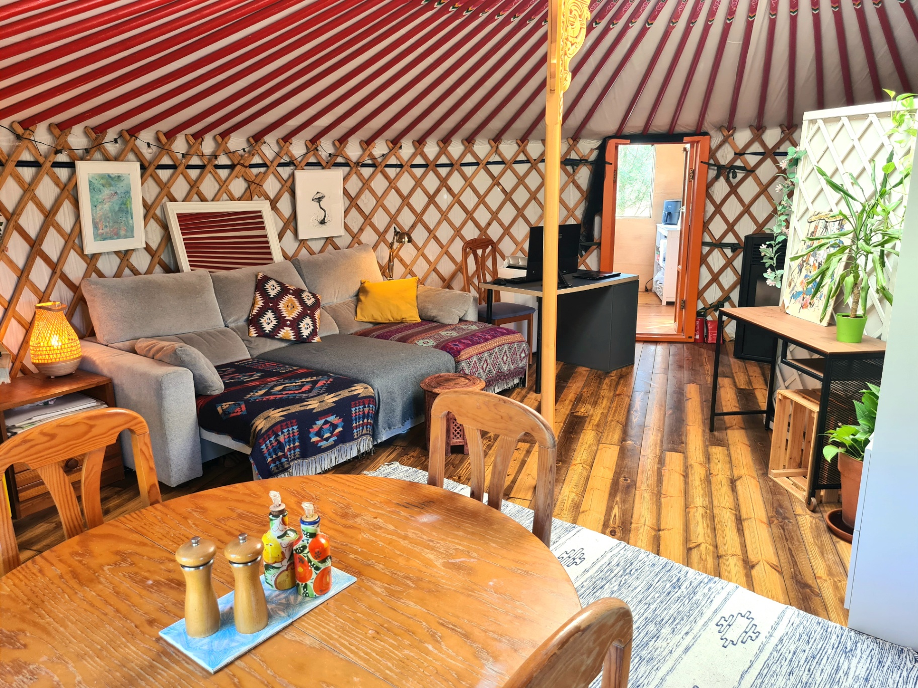 Inside the yurt: sofa, dining table and workspace